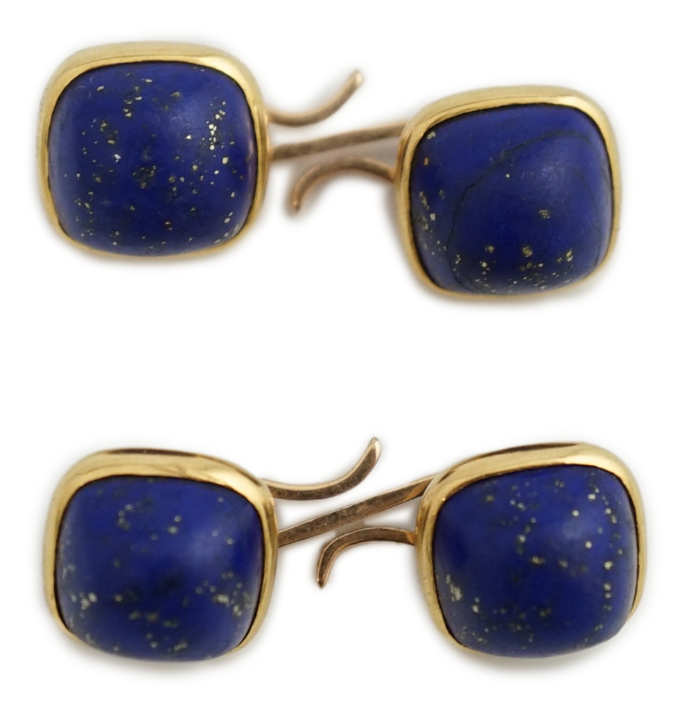 A pair of gold mounted cabochon lapis lazuli set cufflinks